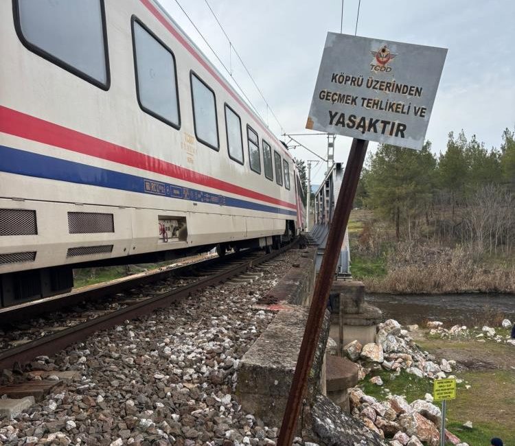 Dursunbey’de geçmenin yasak olduğu tren köprüsünden yürüyen bir kişi trenin
